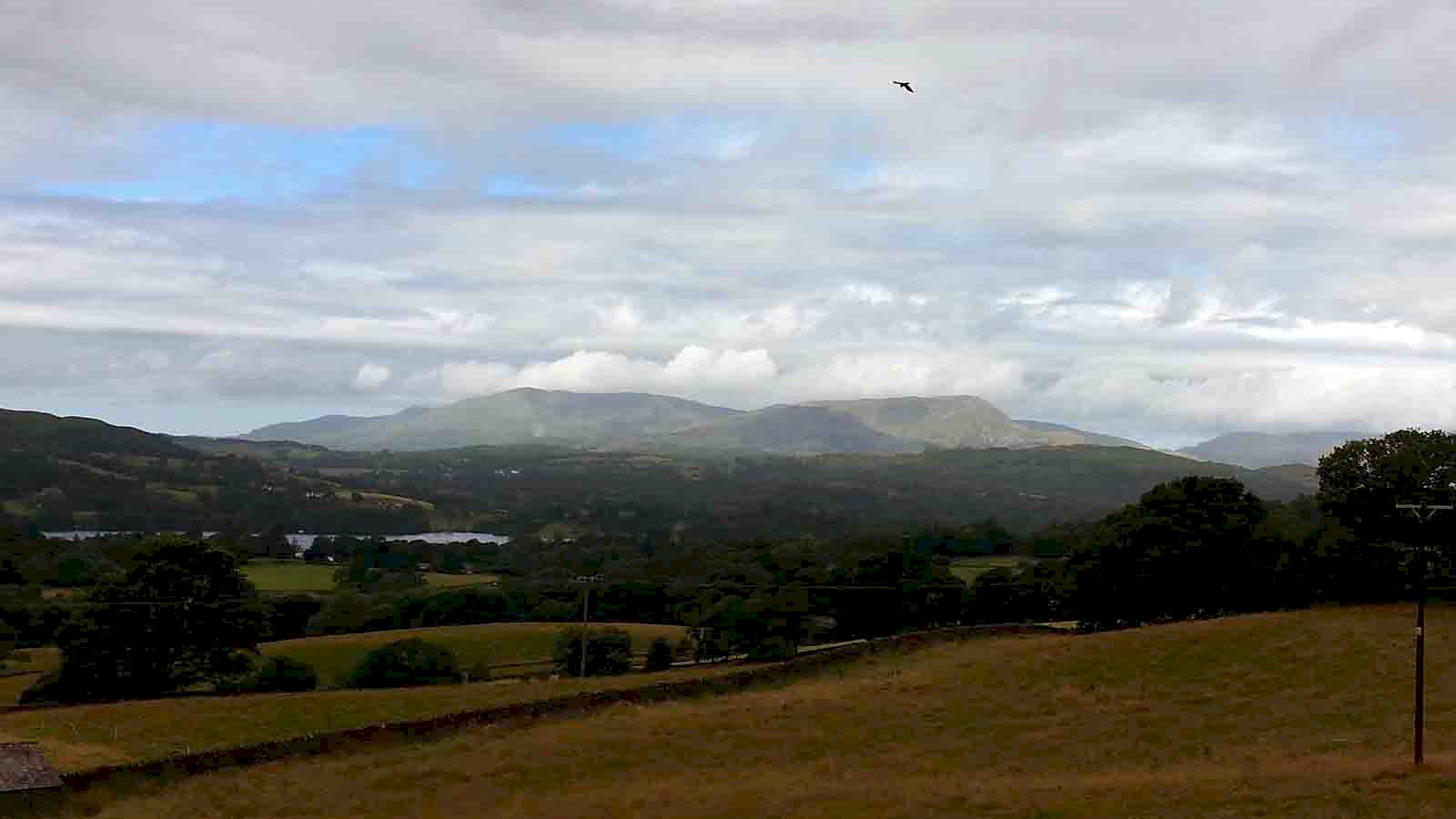 Image of the east face of the Old Man of Coniston on a changeable and unsettled day in the western fells.