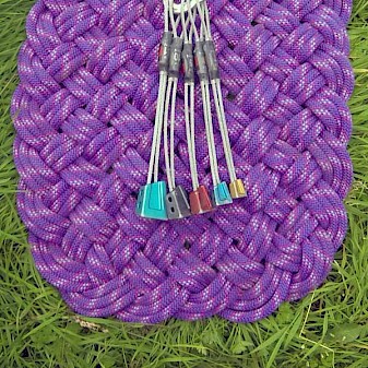 Image of a full set of DMM Alloy Offsets as used by the author, fanned out on a woven rope mat.