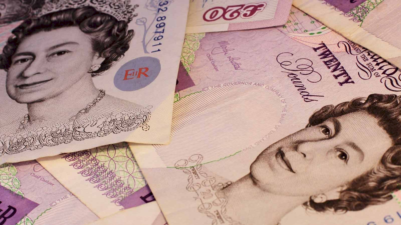 Close up of a pile of old style UK £20 notes.