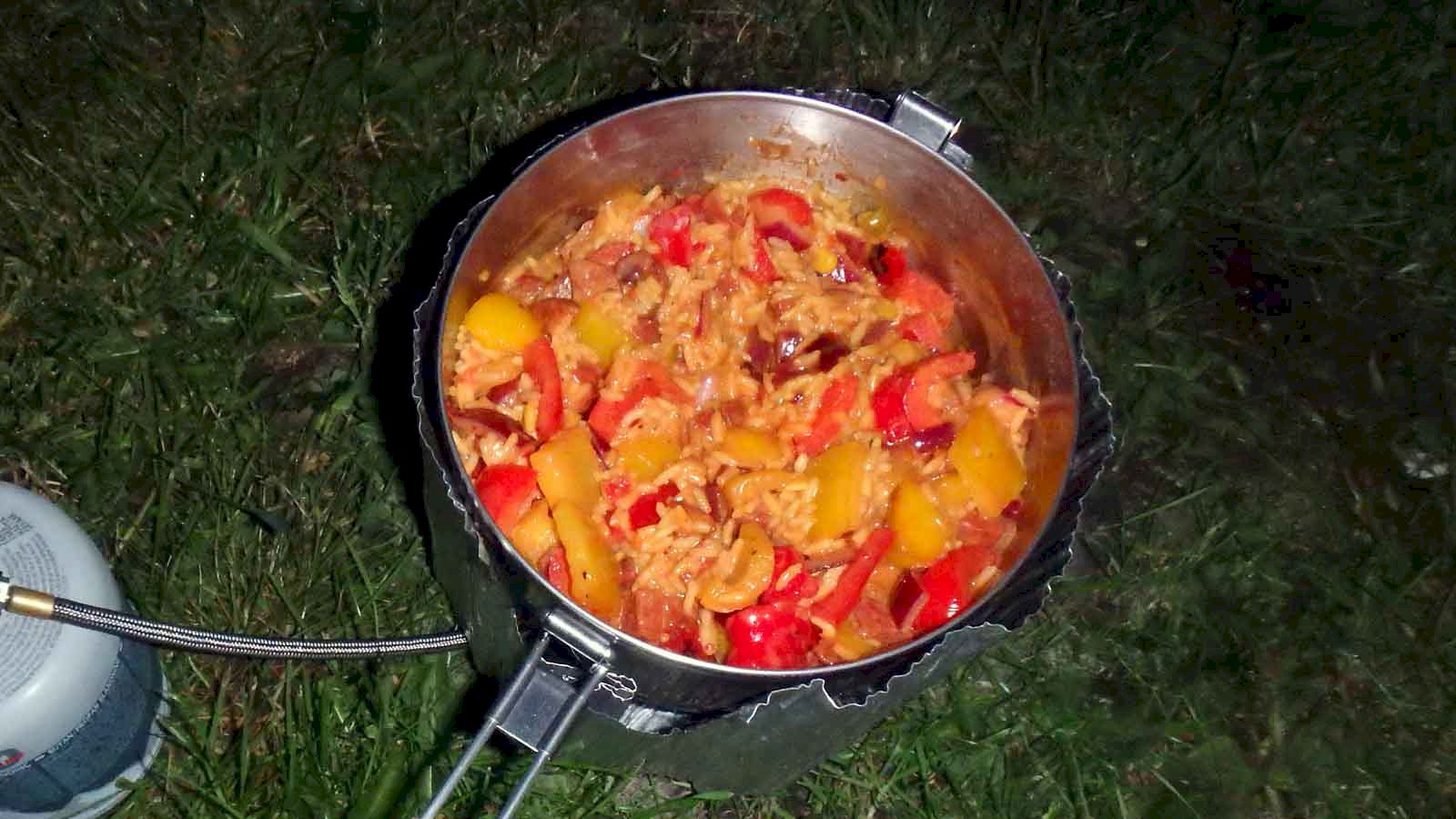 Image of Mexican Fried Rice in a camping pot simmering over a stove.