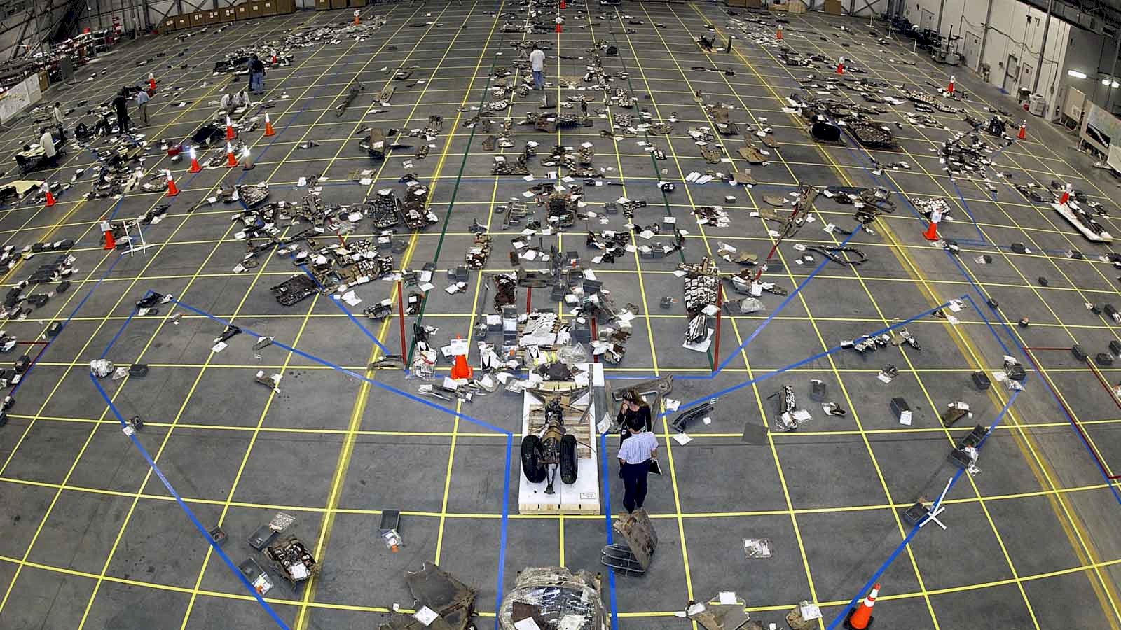Picture showing the debris from the 2003 Columbia Shuttle disaster laid out in a hangar during investigation.