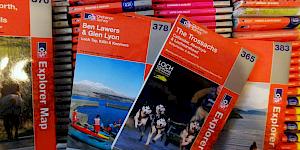 A selection of OS Explorer maps pulled form a larger archive sitting underneath.